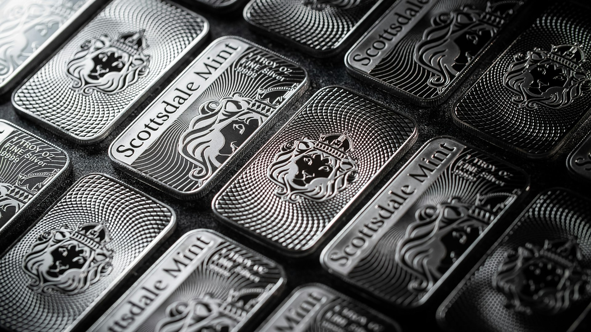 a pile of silver bars sitting on top of a table